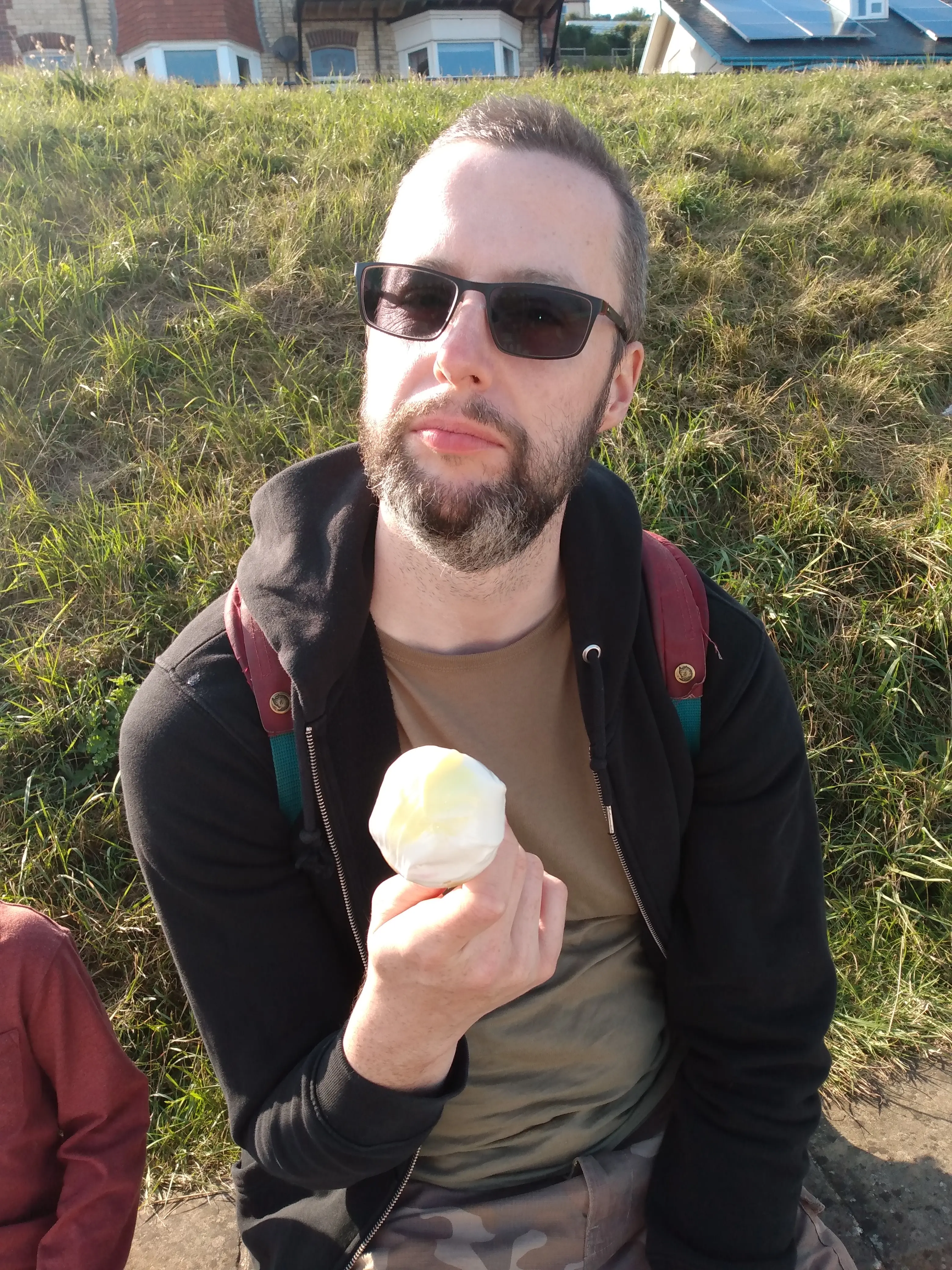 James eating an Ice Cream at the seaside.